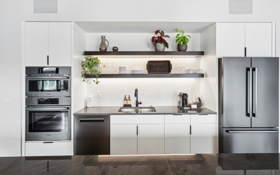Kitchen Area in Clubhouse with Ovens, Dishwasher, Sinke, Shelves and Fridge