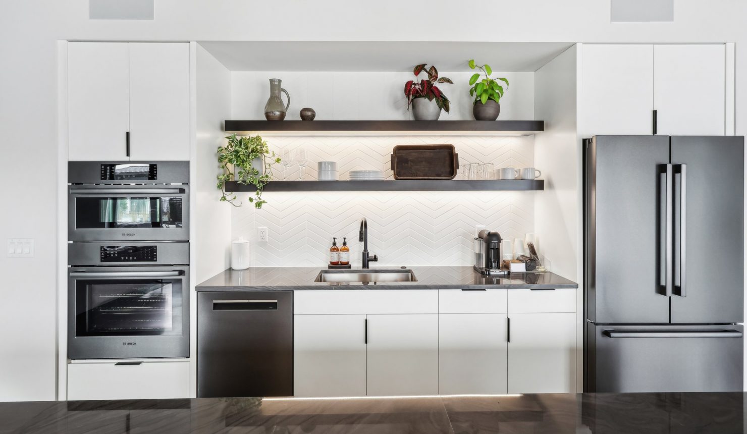 Kitchen Area in Clubhouse with Ovens, Dishwasher, Sinke, Shelves and Fridge