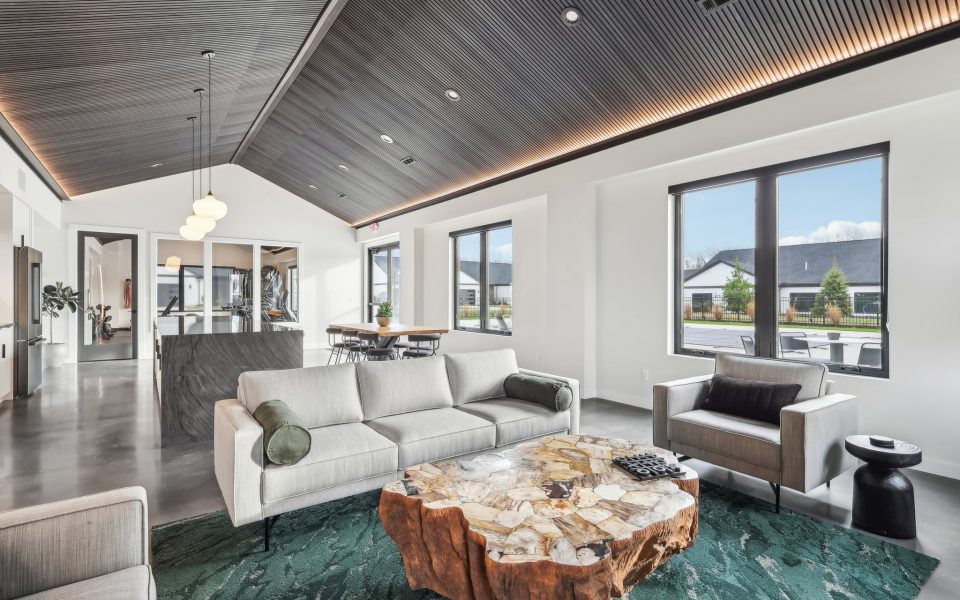 View of the Lounge from the Fireplace looking over the unique wood coffee table and couch