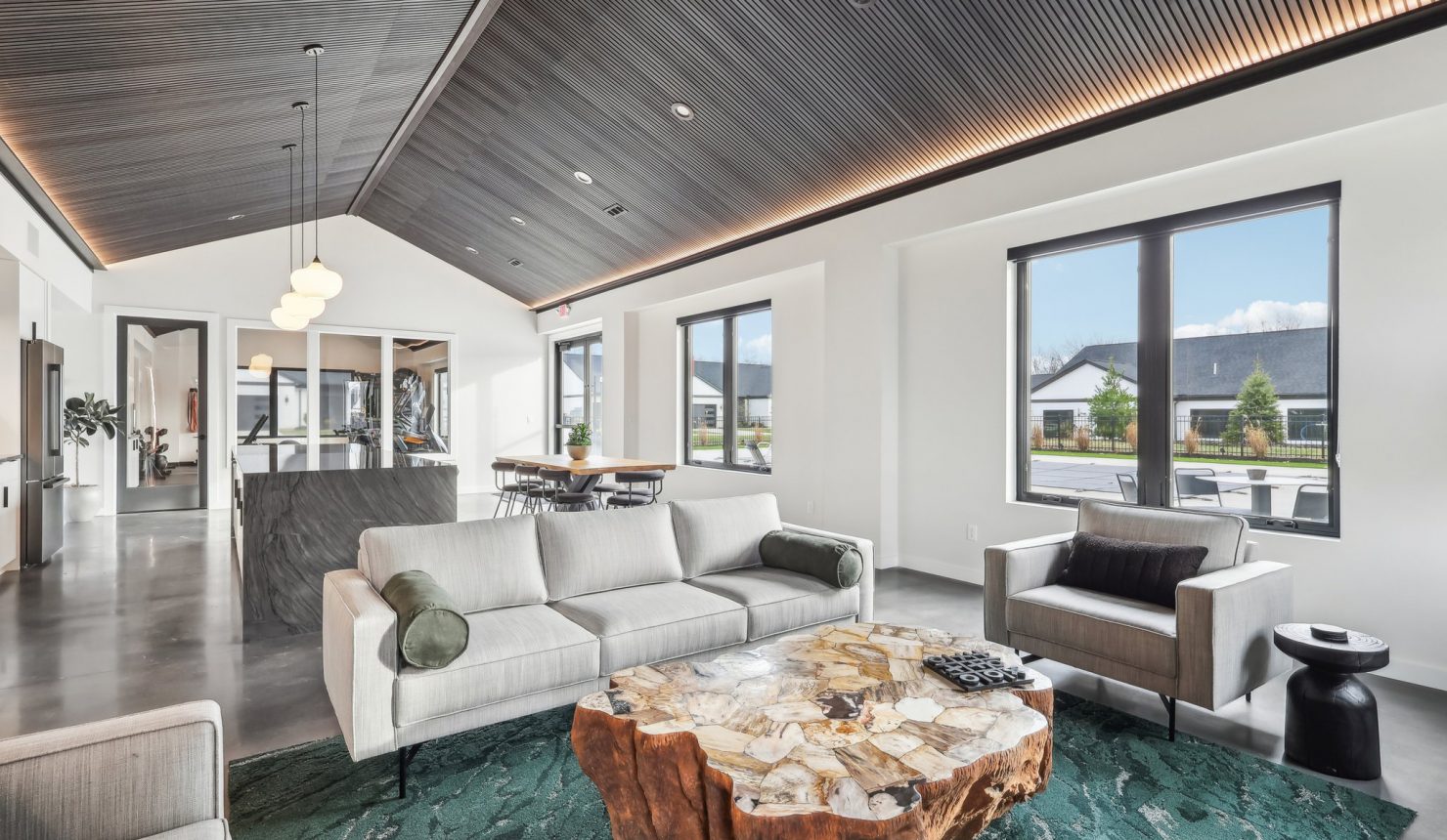 View of the Lounge from the Fireplace looking over the unique wood coffee table and couch