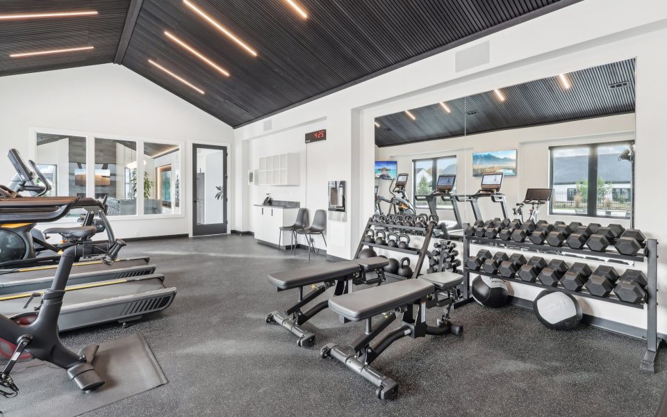 Weight Room Area of Club House Showing Free Weights and Benches