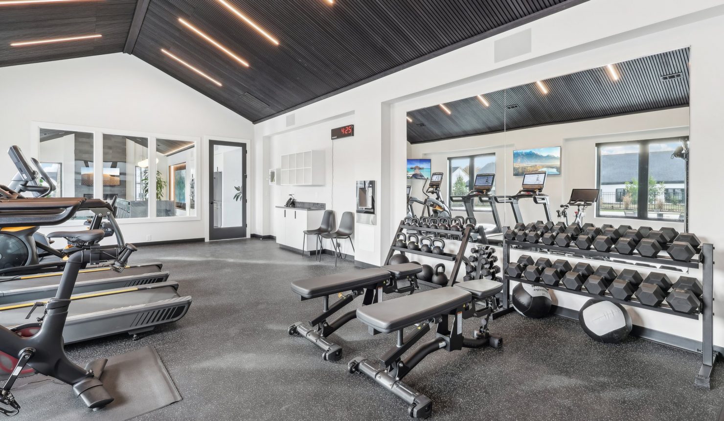 Weight Room Area of Club House Showing Free Weights and Benches
